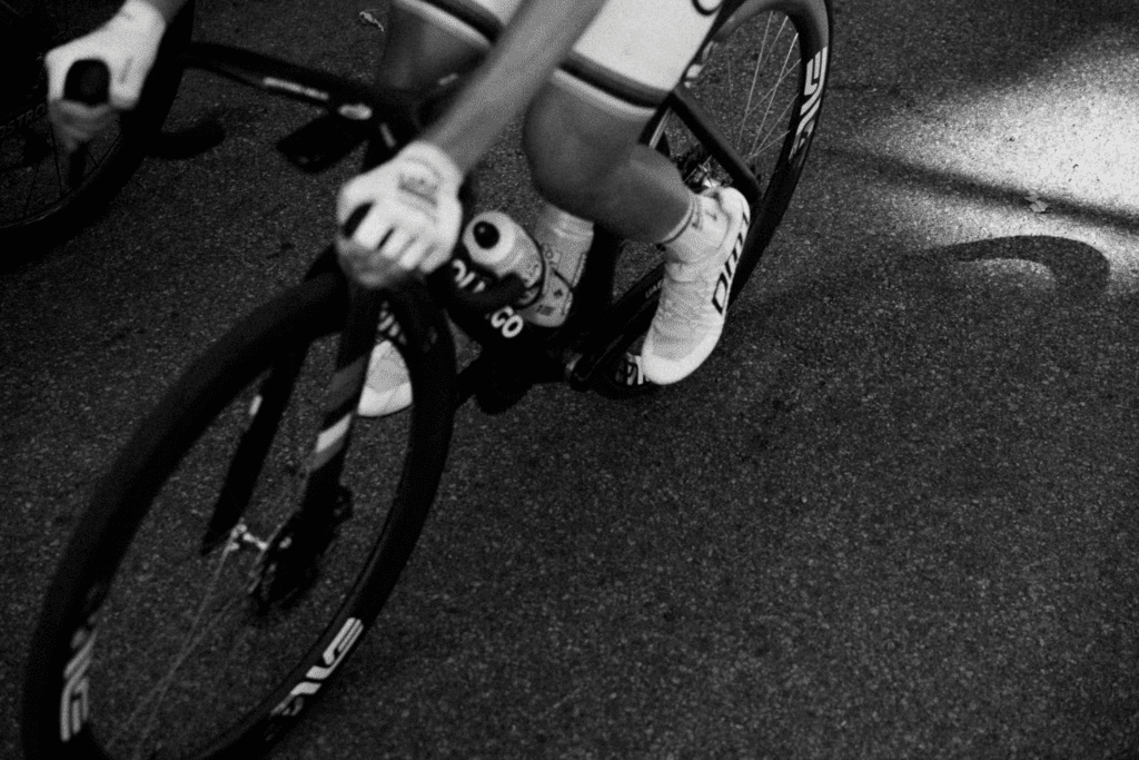Close-up of a cyclist's foot and leg on a bike pedal.