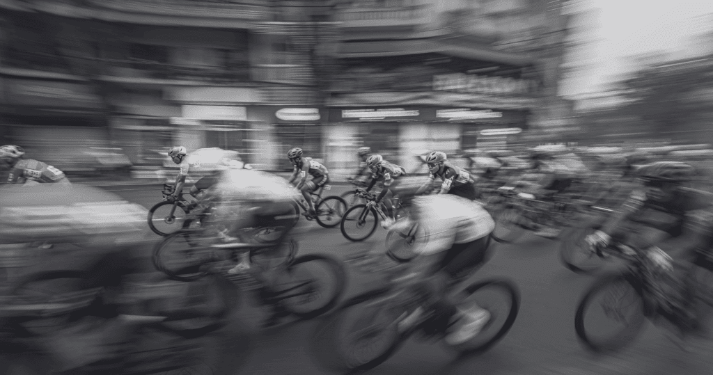 A pack of cyclists racing in a blur of motion.